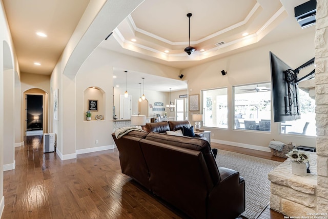 311 Wentworth, Spring Branch, TX 78070 - living area with arched walkways, dark wood finished floors, ceiling fan, ornamental molding, and a tray ceiling