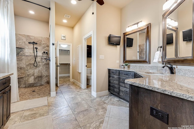 311 Wentworth, Spring Branch, TX 78070 - bathroom with walk in shower, vanity, toilet, baseboards, and ceiling fan