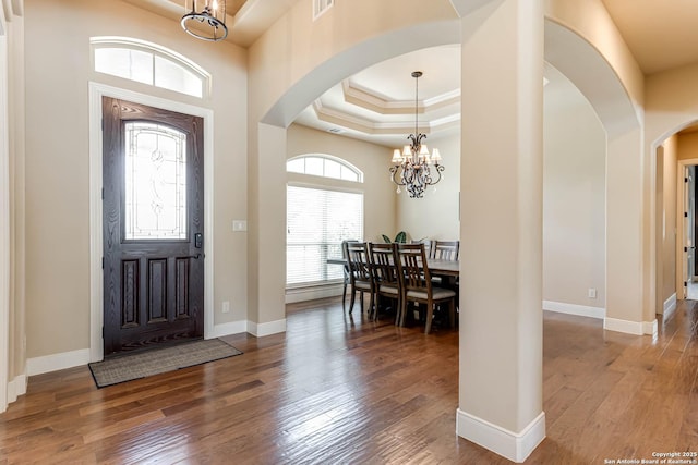 311 Wentworth, Spring Branch, TX 78070 - entryway featuring a chandelier, arched walkways, a raised ceiling, wood-type flooring, and crown molding