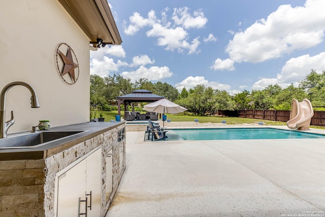 311 Wentworth, Spring Branch, TX 78070 - view of swimming pool featuring a sink, a gazebo, a water slide, a patio area, and area for grilling