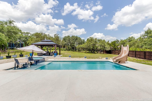 311 Wentworth, Spring Branch, TX 78070 - view of swimming pool featuring a patio area, a gazebo, a water slide, an in-ground hot tub, and view of scattered trees
