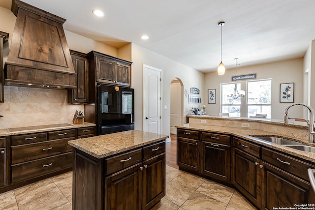 311 Wentworth, Spring Branch, TX 78070 - kitchen featuring a sink, fridge, black electric cooktop, arched walkways, and backsplash
