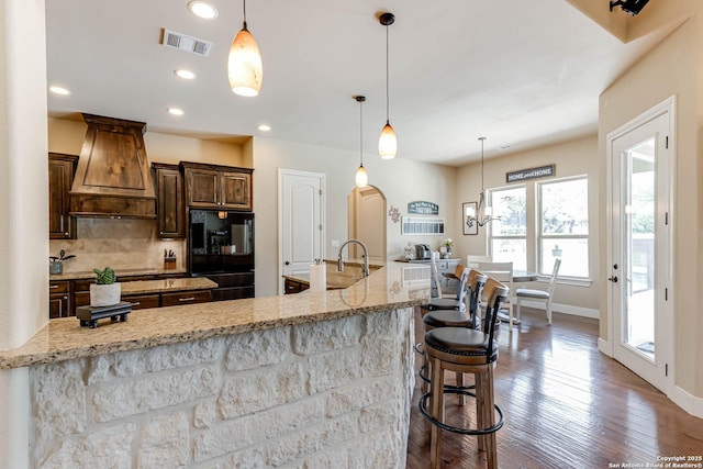 311 Wentworth, Spring Branch, TX 78070 - kitchen with refrigerator, premium range hood, baseboards, backsplash, and light stone counters
