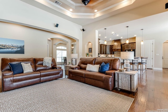 311 Wentworth, Spring Branch, TX 78070 - living area with arched walkways, crown molding, hardwood / wood-style flooring, a raised ceiling, and recessed lighting