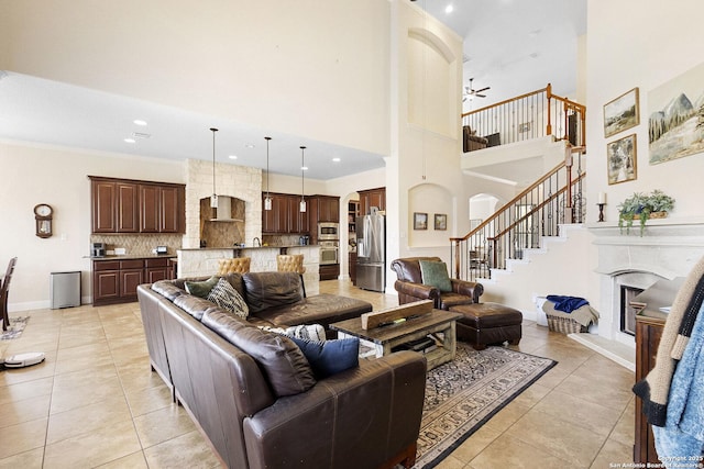 9718 Rosemire Way, San Antonio, TX 78254 - living room featuring a fireplace with raised hearth, light tile patterned floors, a ceiling fan, a towering ceiling, and recessed lighting