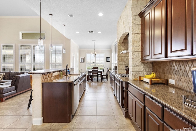 9718 Rosemire Way, San Antonio, TX 78254 - kitchen featuring a sink, a kitchen breakfast bar, light tile patterned floors, stainless steel appliances, and ornamental molding
