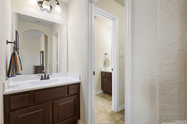 9718 Rosemire Way, San Antonio, TX 78254 - bathroom featuring vanity, a textured wall, and tile patterned floors