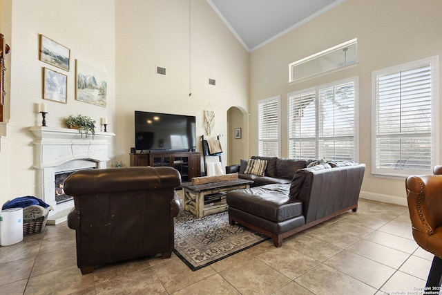 9718 Rosemire Way, San Antonio, TX 78254 - living room with ornamental molding, arched walkways, a warm lit fireplace, baseboards, and high vaulted ceiling