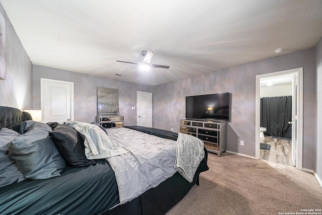 8411 Terlingua Cv, Converse, TX 78109 - carpeted bedroom featuring baseboards, ceiling fan, and ensuite bath
