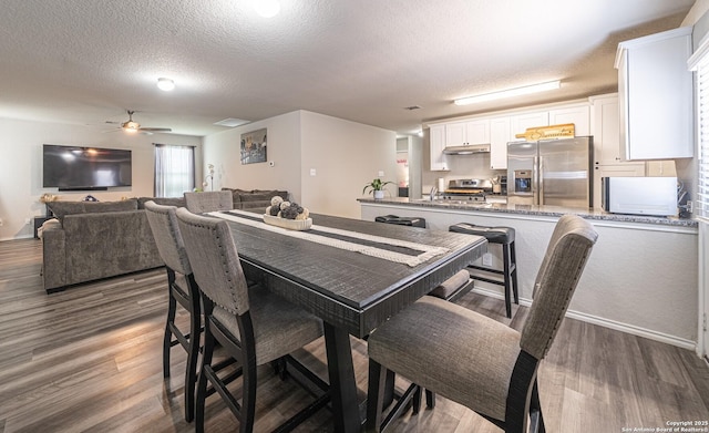 8411 Terlingua Cv, Converse, TX 78109 - dining area featuring a textured ceiling, wood finished floors, and ceiling fan