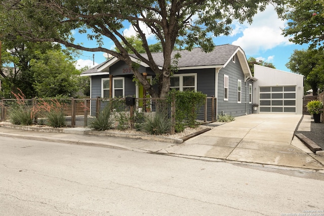 203 Rehmann, San Antonio, TX 78204 - view of front facade with a garage, driveway, a fenced front yard, and a shingled roof