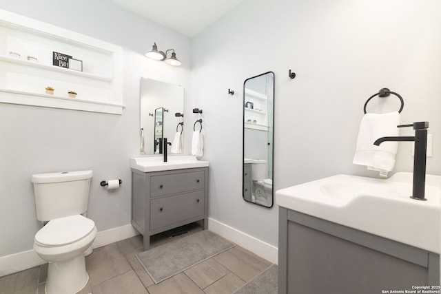 203 Rehmann, San Antonio, TX 78204 - bathroom featuring vanity, baseboards, and toilet