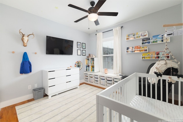 203 Rehmann, San Antonio, TX 78204 - bedroom featuring wood finished floors, baseboards, a crib, and ceiling fan