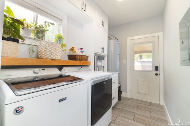 203 Rehmann, San Antonio, TX 78204 - laundry area featuring washing machine and clothes dryer, cabinet space, water heater, wood finish floors, and baseboards