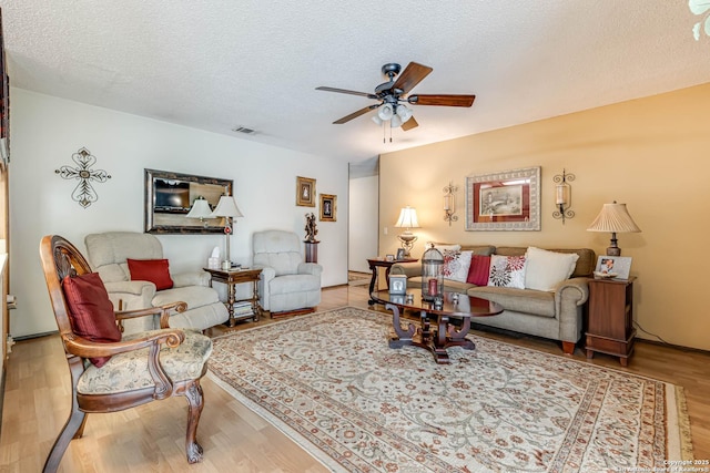 16519 Burr Hill, San Antonio, TX 78247 - living area with ceiling fan, wood finished floors, and a textured ceiling