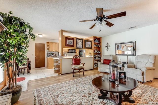 16519 Burr Hill, San Antonio, TX 78247 - living room with a ceiling fan and a textured ceiling