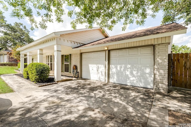 16519 Burr Hill, San Antonio, TX 78247 - view of front of home with brick siding, an attached garage, driveway, and a shingled roof