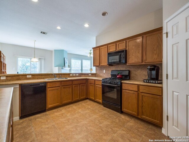 1506 Winston Cv, San Antonio, TX 78260 - kitchen with black appliances, a sink, brown cabinetry, healthy amount of natural light, and recessed lighting