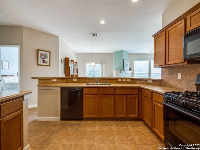 1506 Winston Cv, San Antonio, TX 78260 - kitchen featuring black appliances, a sink, brown cabinetry, backsplash, and recessed lighting