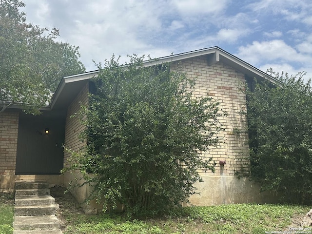 11618 Spring Trail St, San Antonio, TX 78249 - view of side of property featuring brick siding