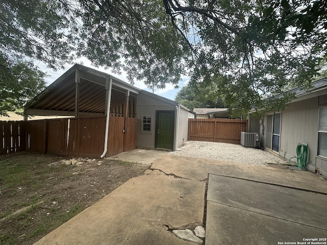 11618 Spring Trail St, San Antonio, TX 78249 - view of home's exterior with a fenced backyard, a patio, and central AC unit