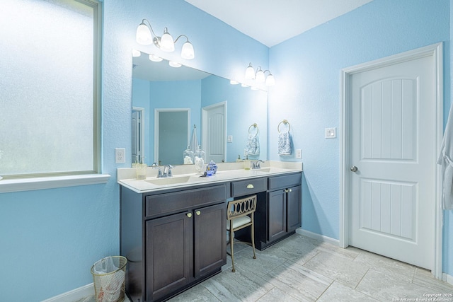 2705 Merlin Ln, Pearland, TX 77581 - full bath with double vanity, baseboards, and a textured wall