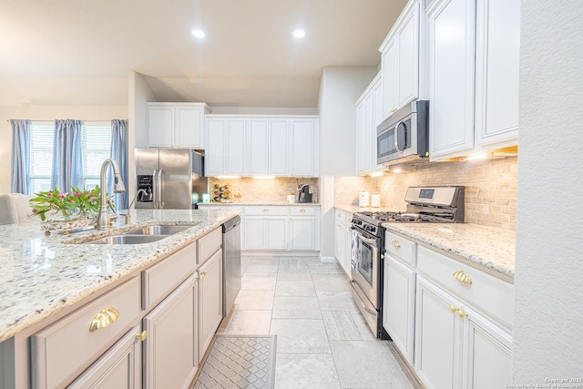 2705 Merlin Ln, Pearland, TX 77581 - kitchen with appliances with stainless steel finishes, a sink, decorative backsplash, recessed lighting, and white cabinets