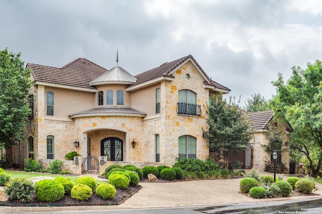 10 Kings Tower, San Antonio, TX 78257 - french provincial home featuring stucco siding, stone siding, a gate, and french doors
