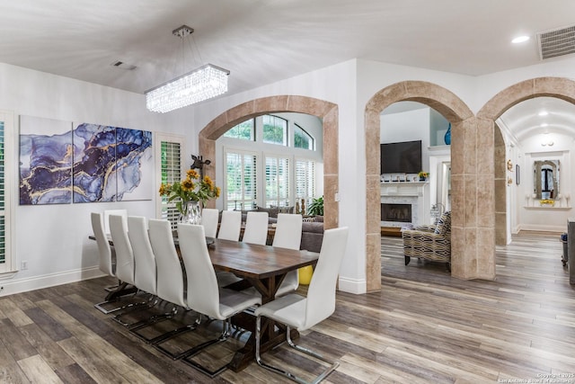 10 Kings Tower, San Antonio, TX 78257 - dining area featuring wood finished floors, a fireplace, arched walkways, a chandelier, and recessed lighting