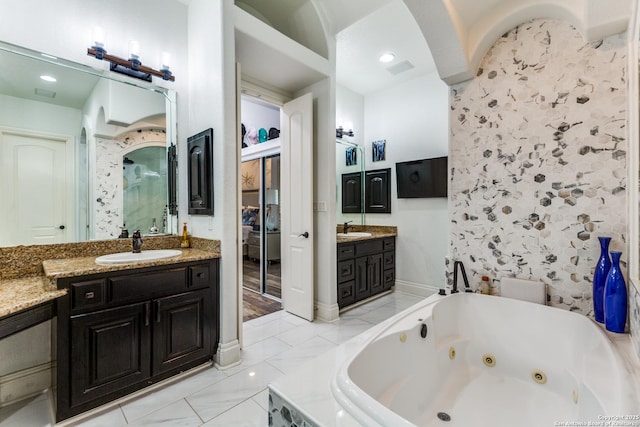 10 Kings Tower, San Antonio, TX 78257 - bathroom with a jetted tub, two vanities, and marble finish flooring