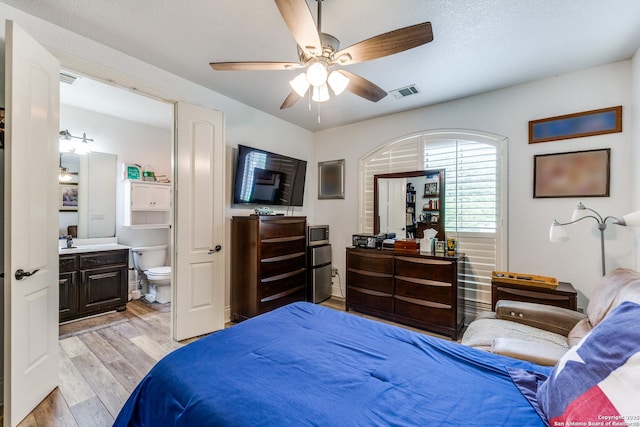 10 Kings Tower, San Antonio, TX 78257 - bedroom featuring light wood-style flooring, ensuite bath, and a ceiling fan