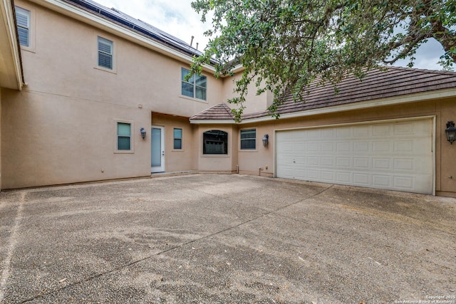 10 Kings Tower, San Antonio, TX 78257 - back of property with driveway, stucco siding, a tile roof, and a garage