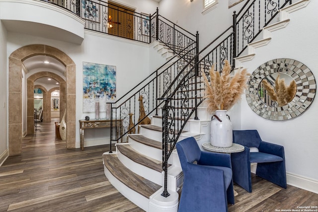10 Kings Tower, San Antonio, TX 78257 - stairs with a high ceiling, arched walkways, wood finished floors, and baseboards