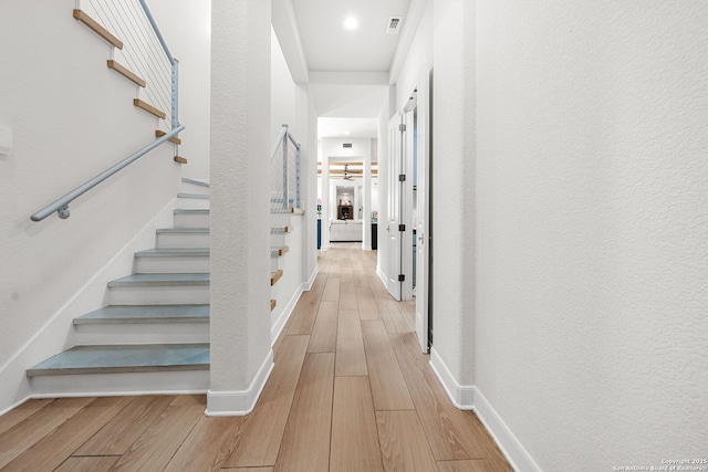195 Desert Flower, Spring Branch, TX 78070 - corridor with light wood-style floors, stairs, and baseboards