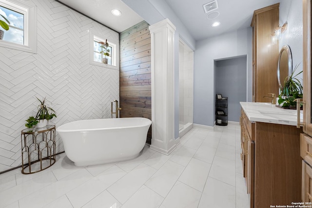 195 Desert Flower, Spring Branch, TX 78070 - full bathroom featuring vanity, a soaking tub, healthy amount of natural light, decorative columns, and recessed lighting