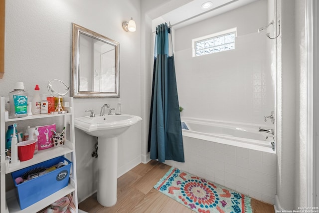 195 Desert Flower, Spring Branch, TX 78070 - full bath featuring tiled shower / bath combo, a sink, and wood finished floors