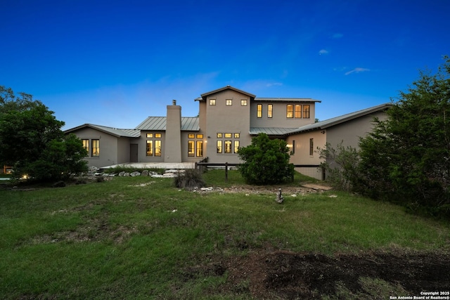 195 Desert Flower, Spring Branch, TX 78070 - back of house featuring a standing seam roof, stucco siding, metal roof, and a chimney