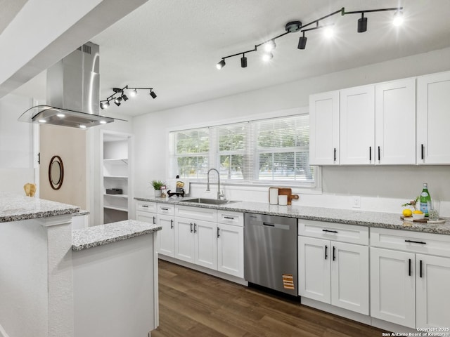 942 San Angelo, San Antonio, TX 78201 - kitchen with stainless steel dishwasher, a sink, wall chimney exhaust hood, white cabinets, and dark wood-type flooring