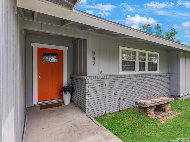 942 San Angelo, San Antonio, TX 78201 - doorway to property featuring brick siding and board and batten siding