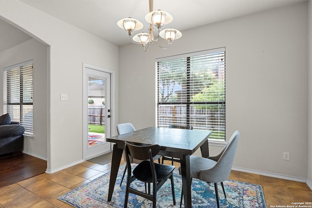 9815 Leubeck Rnch, Helotes, TX 78023 - dining space featuring healthy amount of natural light, a chandelier, baseboards, and tile patterned floors