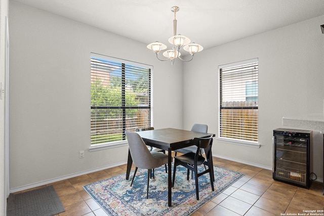 9815 Leubeck Rnch, Helotes, TX 78023 - tiled dining space featuring beverage cooler, a chandelier, and baseboards