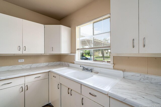 222 Laurelwood, San Antonio, TX 78213 - kitchen featuring a sink, light countertops, and white cabinetry