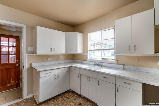 222 Laurelwood, San Antonio, TX 78213 - kitchen featuring light countertops, white cabinetry, and a sink