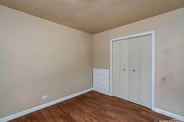 222 Laurelwood, San Antonio, TX 78213 - unfurnished bedroom with baseboards, dark wood finished floors, and a closet