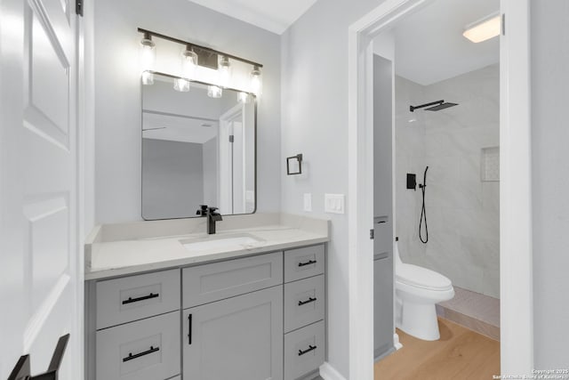 9807 Boulder Hill, San Antonio, TX 78250 - full bath featuring vanity, toilet, a tile shower, and wood finished floors