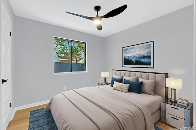 9807 Boulder Hill, San Antonio, TX 78250 - bedroom featuring light wood finished floors, a ceiling fan, and baseboards