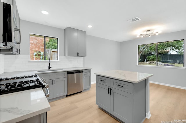 9807 Boulder Hill, San Antonio, TX 78250 - kitchen with stainless steel dishwasher, gray cabinets, light wood-type flooring, and recessed lighting
