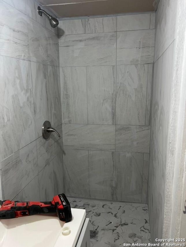 330 E Hart, San Antonio, TX 78214 - full bathroom featuring a tile shower, vanity, and marble look tiles