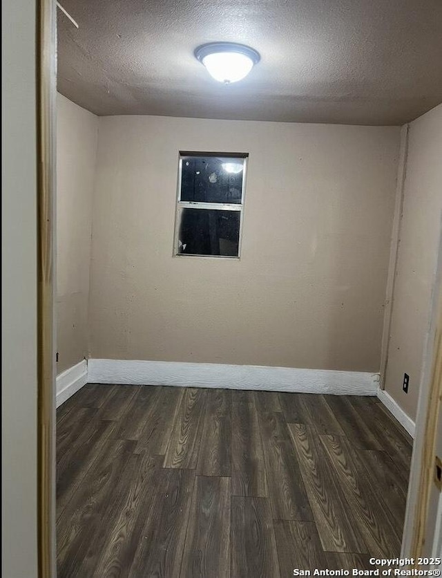 330 E Hart, San Antonio, TX 78214 - empty room featuring dark wood-style floors and a textured ceiling