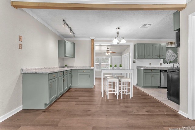 239 Banbridge, San Antonio, TX 78223 - kitchen featuring crown molding, ceiling fan, wood finished floors, light countertops, and a sink